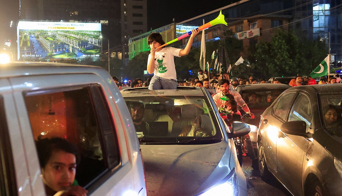 A child uses a vuvuzela during the celebration of Independence Day in Lahore on August 14, 2025. - Reuters
