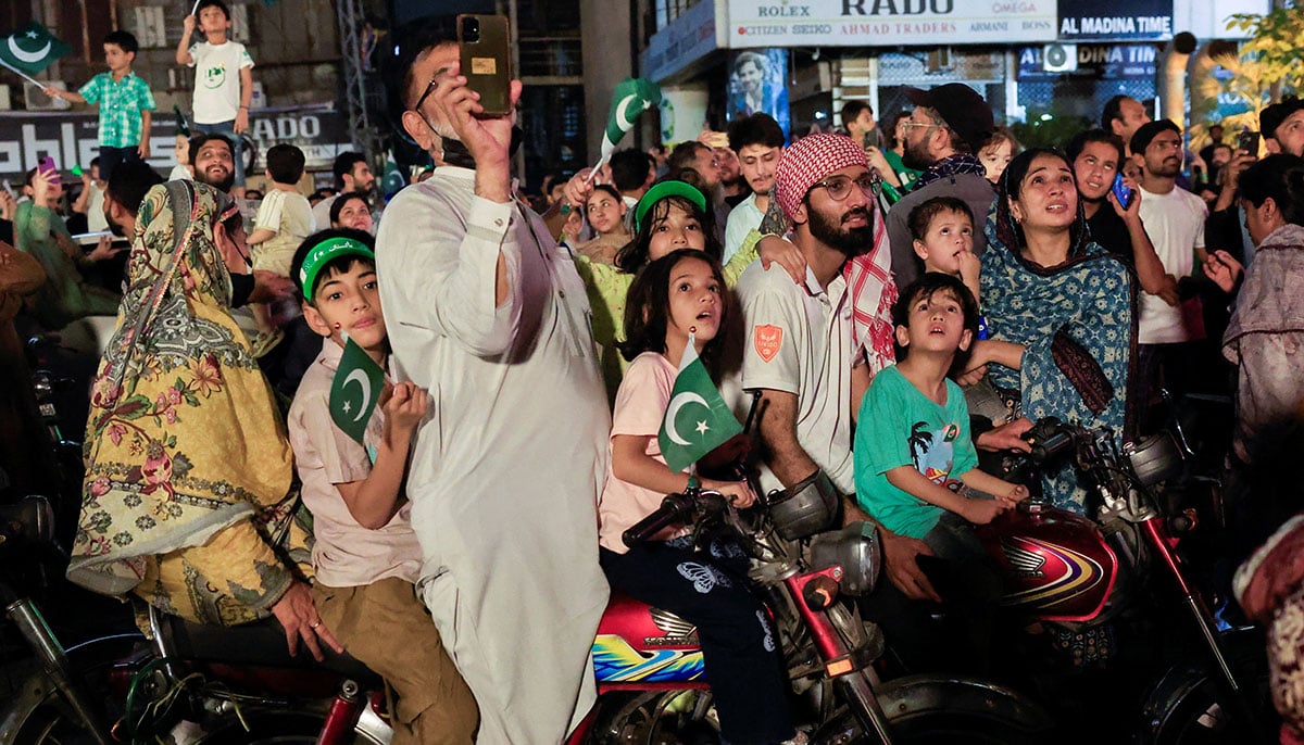 People look at artificial fires during the celebration of Independence Day in Lahore on August 14, 2025. - Reuters