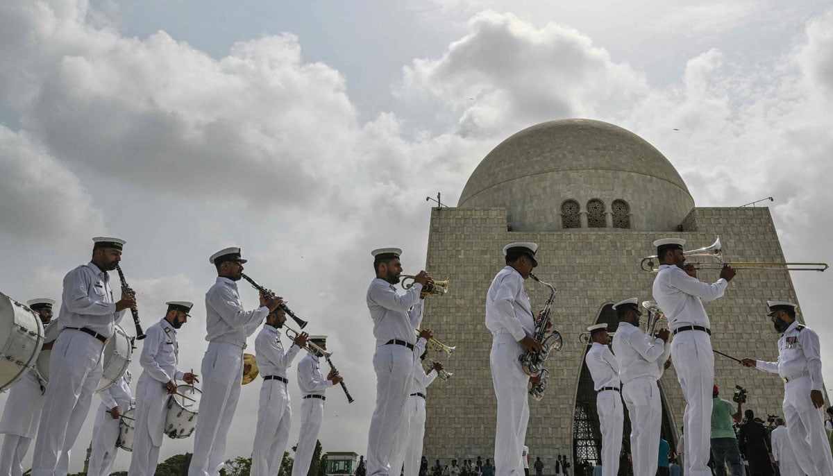 The Pakistani naval cadets play the national anthem in the mausoleum of Muhammad Ali Jinnah, during the celebrations of Independence Day in Karachi on August 14, 2025. - AFP