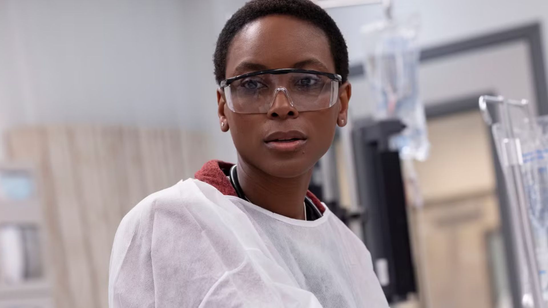 Dr. Collins uses robes and surgical glasses, looking