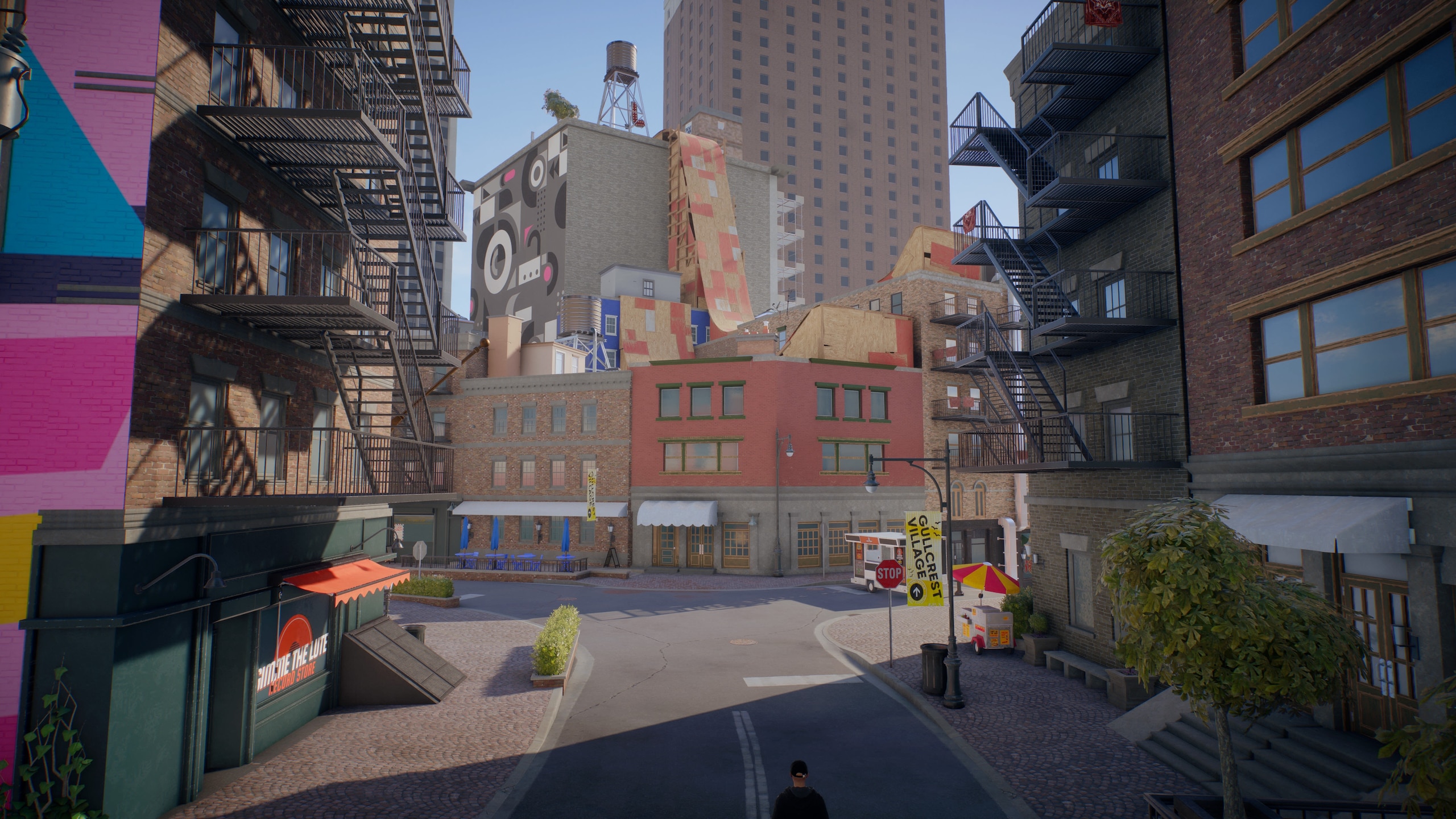 An area of ​​Sanvansterdam: Colorful buildings with large ramps on the roofs and a skyscraper in the distance