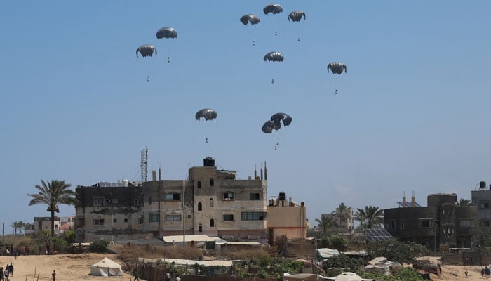 Help packages fell from an airplane descend on Gaza, in Zawayda, in the central strip of Gaza on August 3, 2025. - Reuters