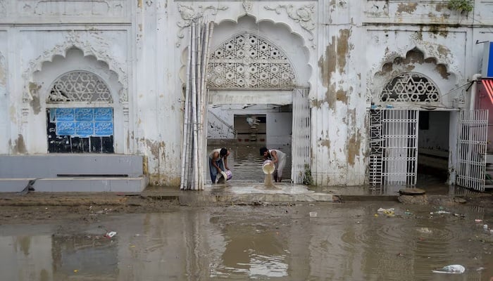 Men remove water from a mosque after heavy rains in Karachi, Pakistan, August 20, 2025. - Reuters