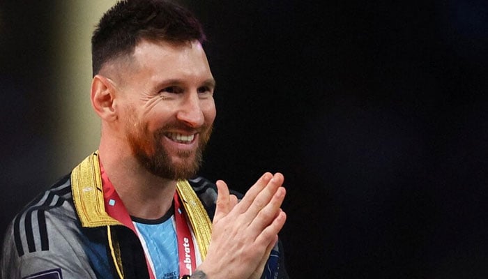 Argentinas Lionel Messi celebrates during the presentation of the trophy after winning the World Cup at the Qatar 2022 FIFA World Cup on December 18, 2022. - Reuters
