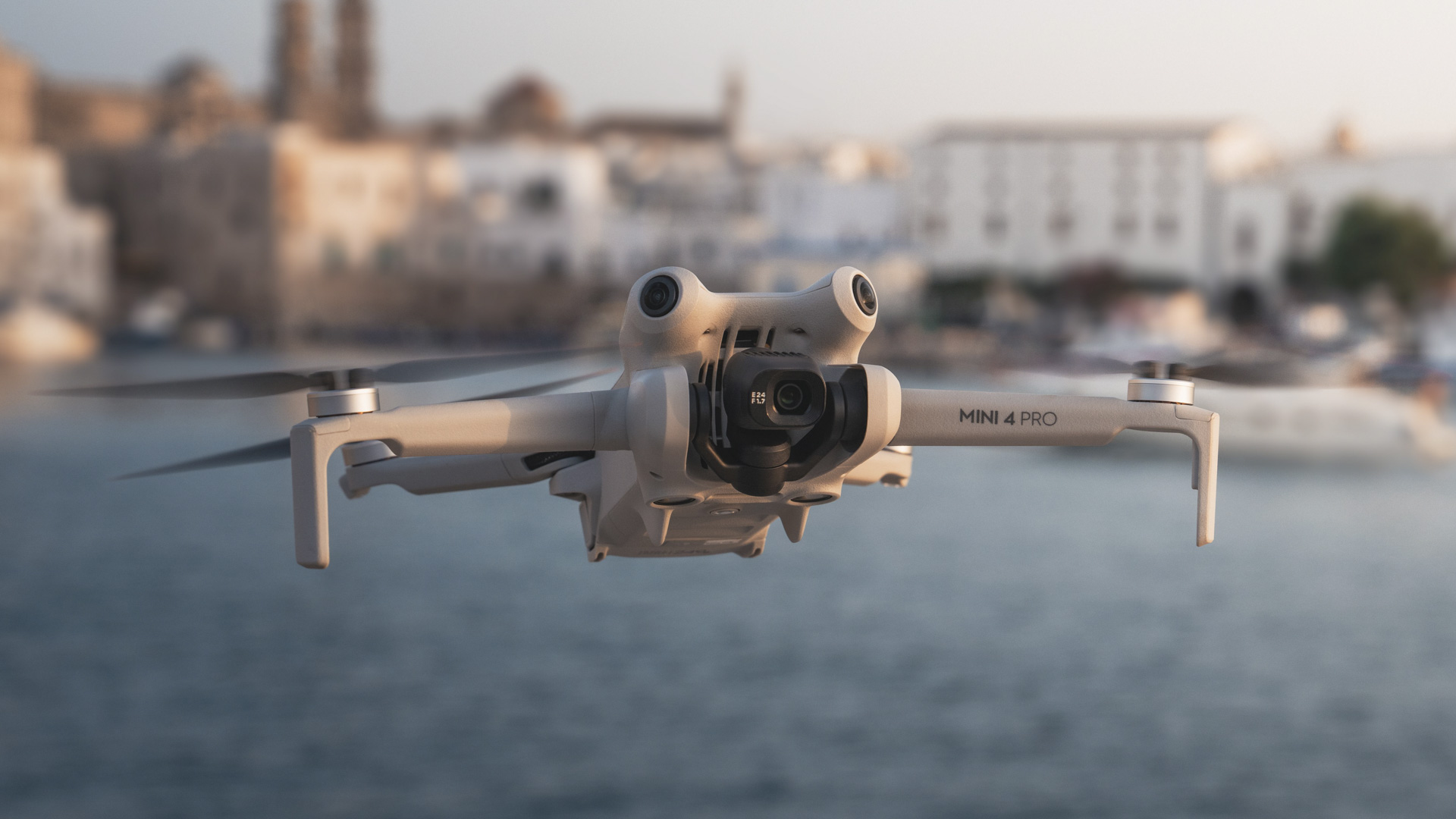 DJI Mini 4 pro in flight at the golden time with ocean and coastal city in the background