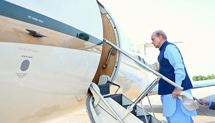Prime Minister Shehbaz Sharif absolves a plane in this image without date. - App/file