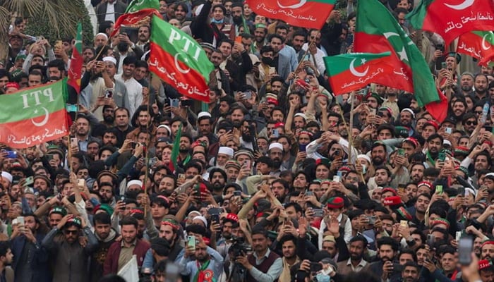 The supporters of Pakistan Tehreek-E-Insaf (PTI) Wave Flags while protesting demanding free and righteous results of the elections, in Peshawar on February 17, 2024.-Reuters