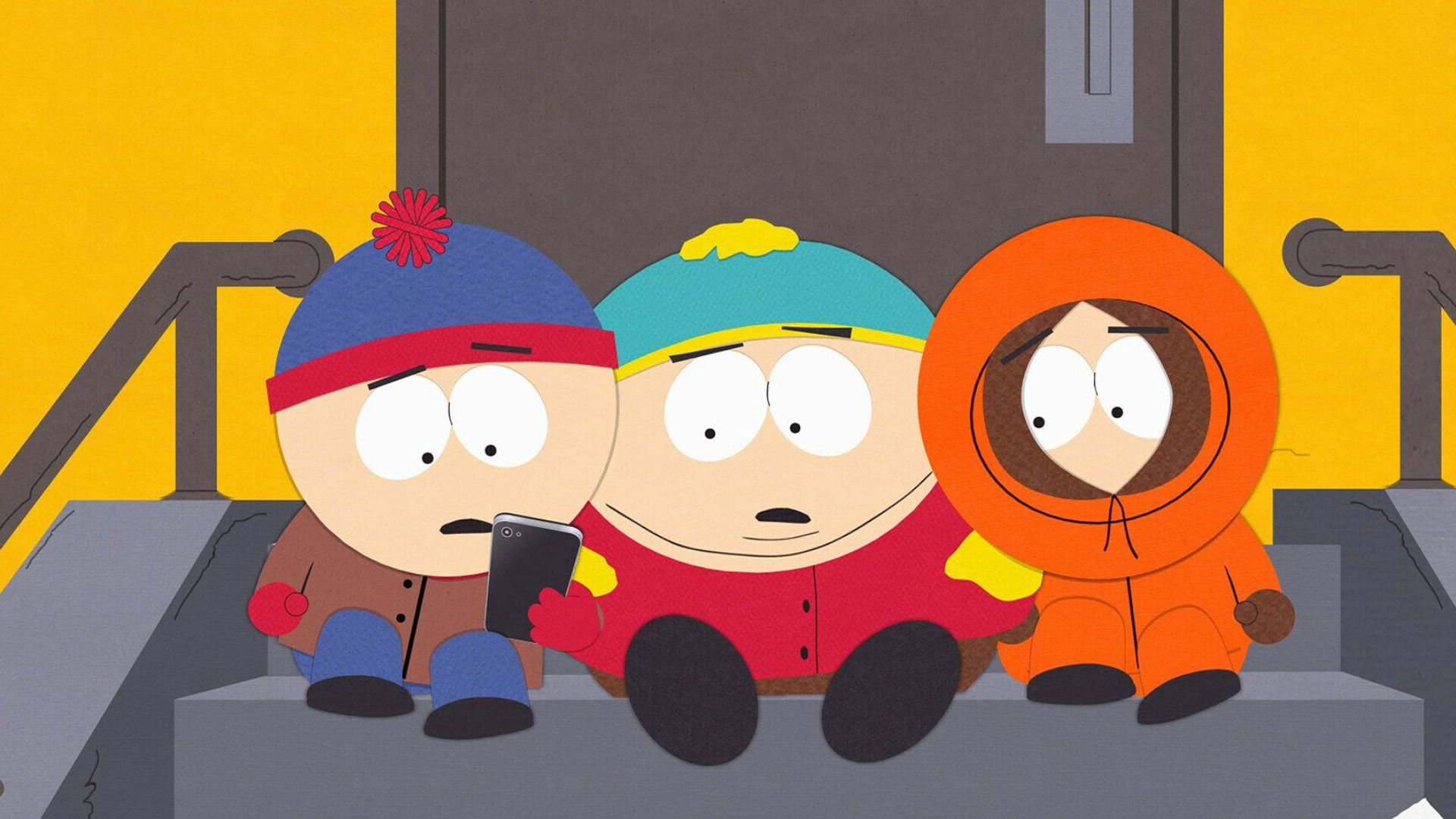 Kenny, Stan and Eric look at something on Stan's phone while sitting on a ladder