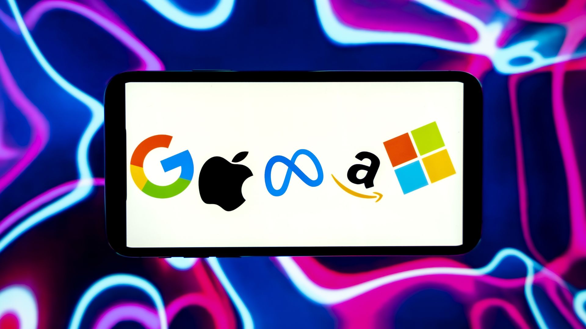 In this photo illustration, the big technology companies Google, Apple, Meta, Amazon and Microsoft logos are seen on the screen of a mobile phone.