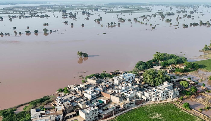 This aerial photograph shows submerged houses with flood water in Chak Ali Sher Village in the Wazirabad district on August 28, 2025. - AFP