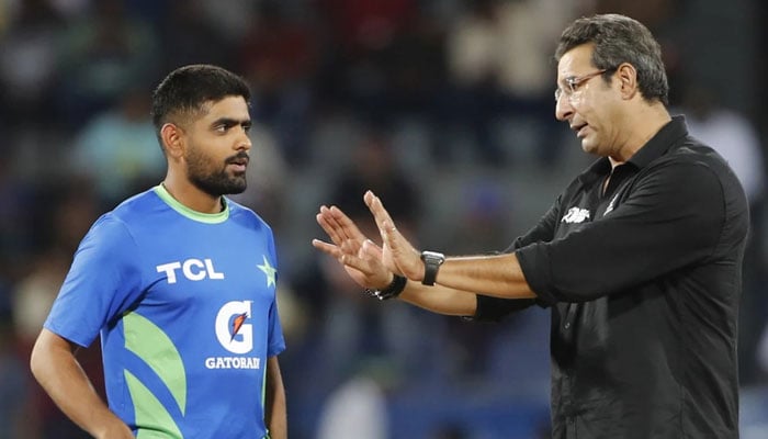 Pakistan's former Cricket player, Wasim Akram (right) interacts with Captain Babar Azam during rain holidays at his ACC Mens Asia Cup 2023 Super Four Match against India at the premium R Stadium R in Colombo on September 10, 2023.