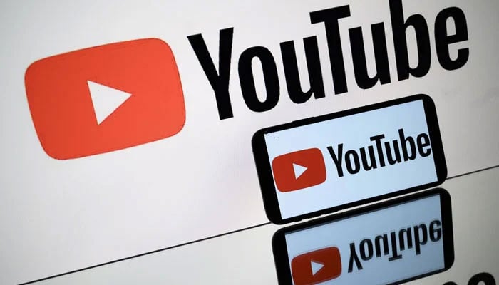 A photo taken in Toulouse shows the logo of YouTube social networks shown by a tablet and a smartphone on October 5, 2021. - AFP