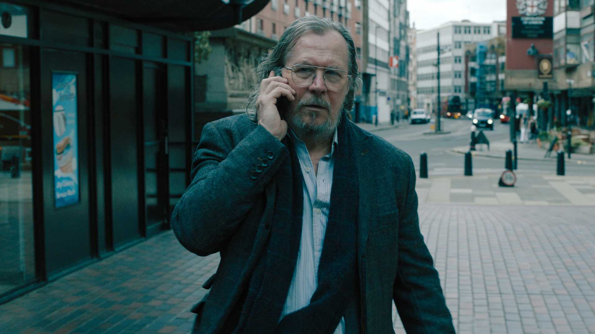 Jackson Lamb walks while talking on the phone in the slow horses season 4