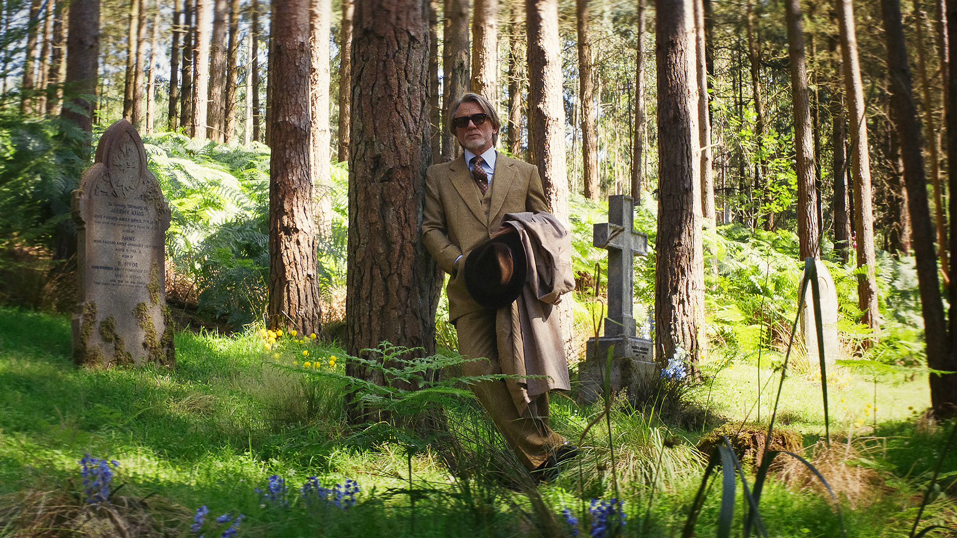 Benoit Blanc supported against a tree on Wake Up Dead Man: A KNIVES OUT MYSTERY