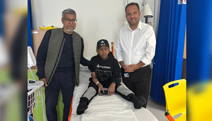 Dr. British-Pakistani Sher Bahadur Anjum (right), originally from Gilgit Baltistan, meets a patient with talaasemia after his successful treatment of gene therapy. - Reporter