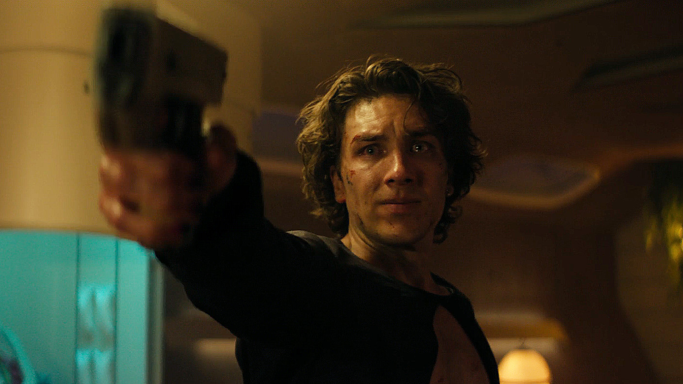 Toran Mallow with crying eyes wielding a gun in Foundation Season 3 Episode 7