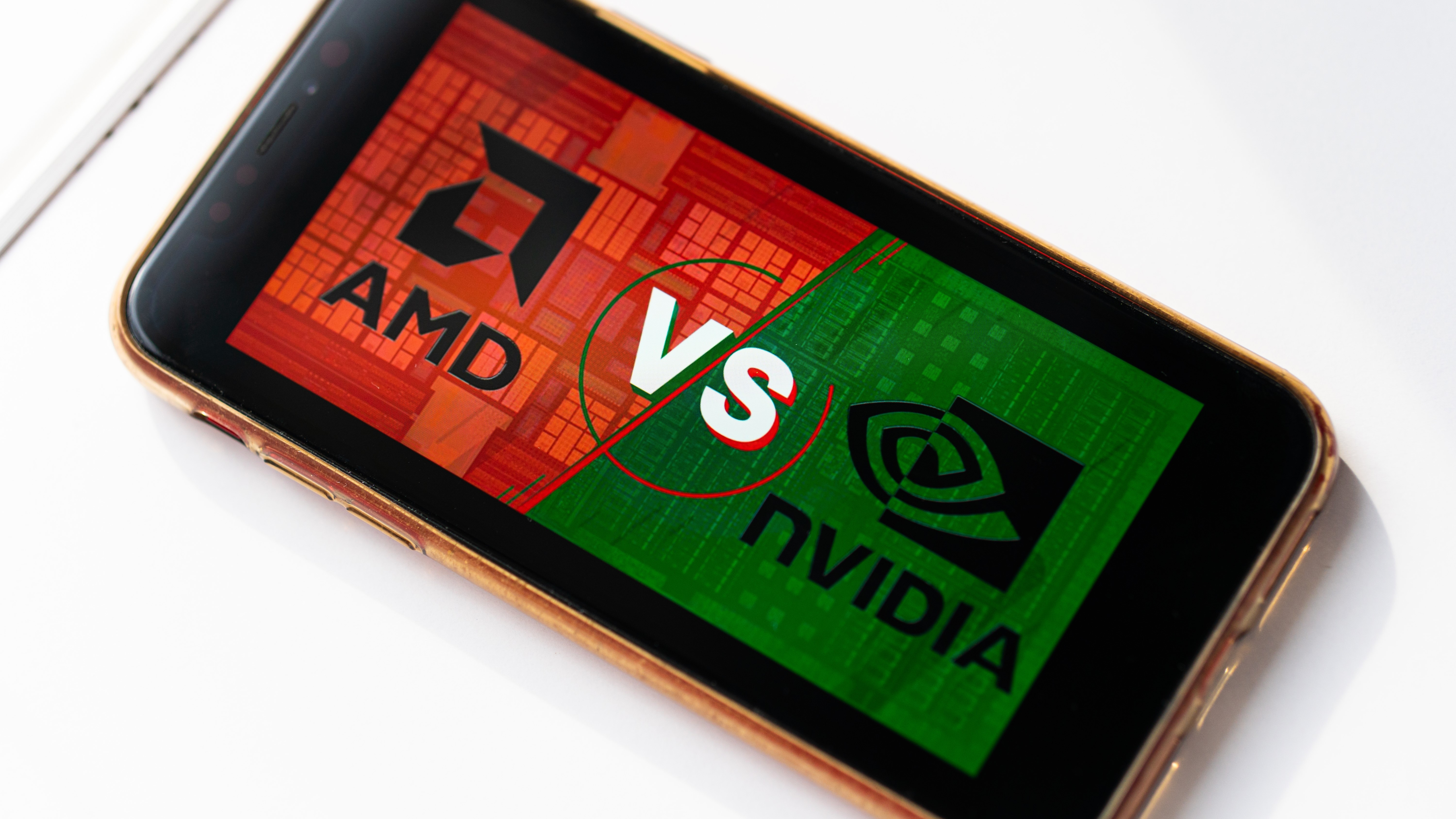 A smartphone showing a red and green graphic of 'AMD vs nvidia'.