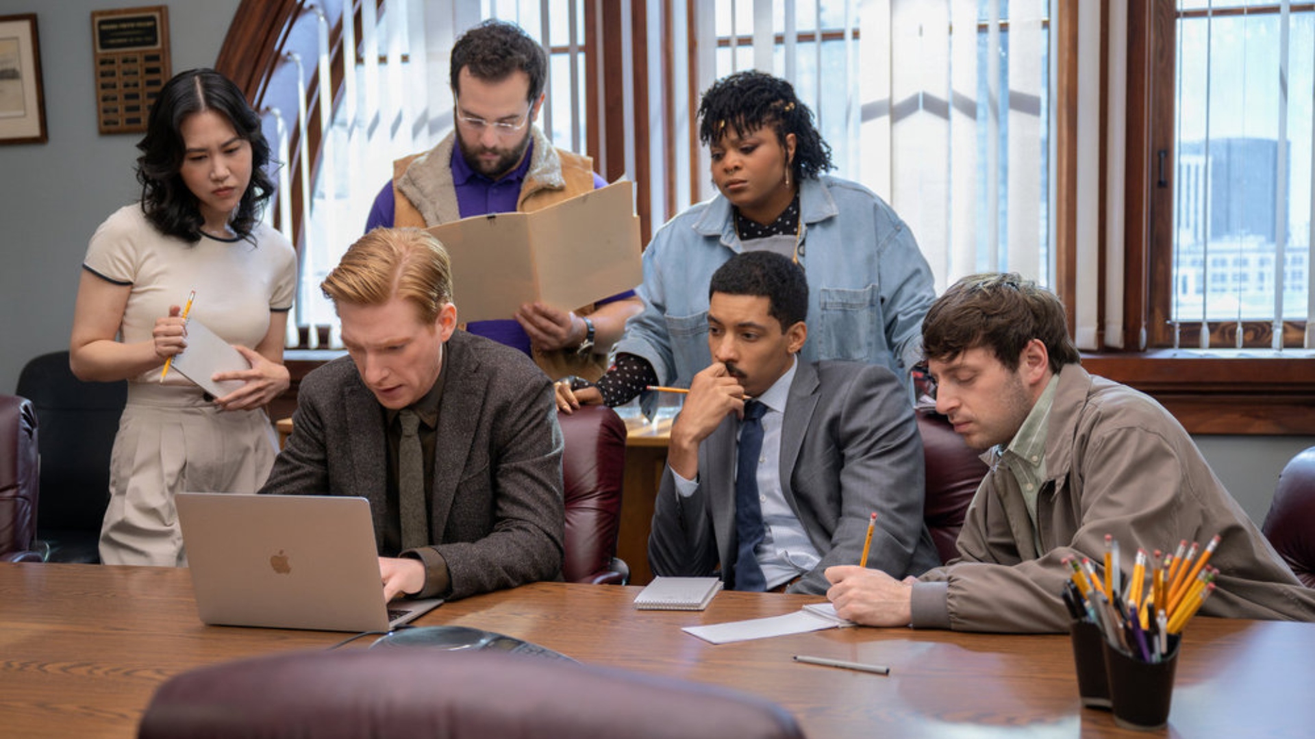 The staff meets around a laptop in season 1 season 1