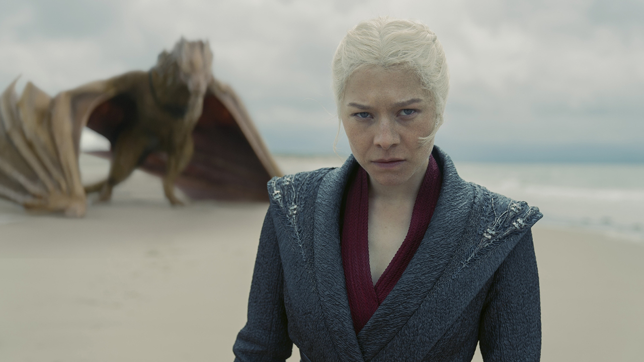 Rhaenyra Targaryen Scowling while located on a beach with Syrax in the background in season 2 of Dragon House 2