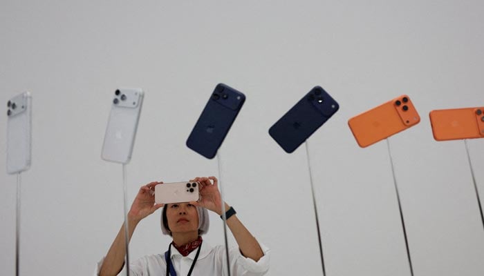A woman takes photos of iPhones during the apple event at the Steve Jobs Theater in Cupertino, California, USA, September 9, 2025. - Reuters