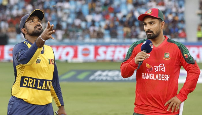 The captain of Sri Lanka, Charith Asalanka (left) turns the coin when Bangladeshs Litton Das makes the call at the launch of his ACC Mens T20 Asia Cup 2025 match at the Dubai International Cricket Stadium in Dubai on September 20, 2025.