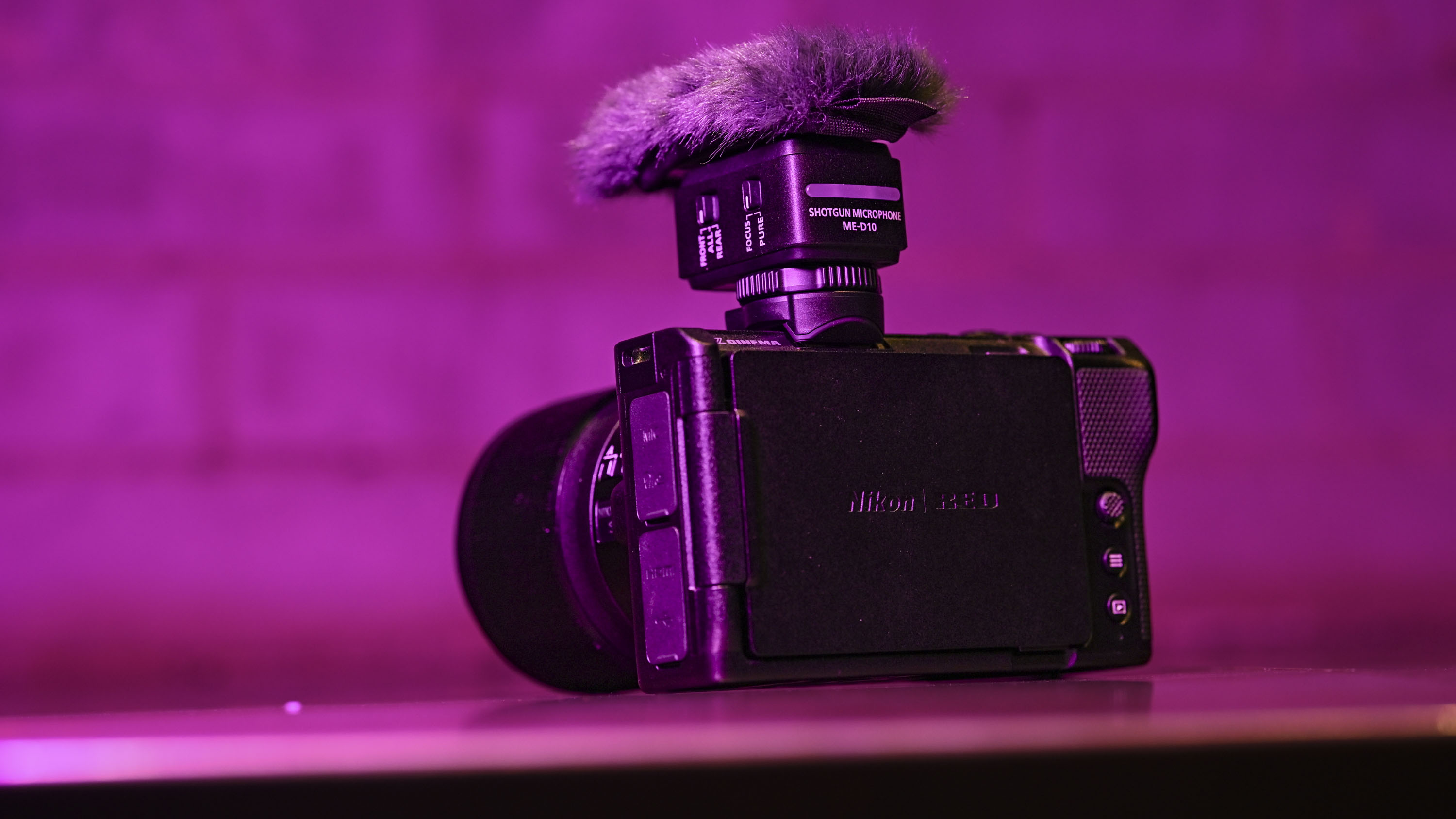 Nikon ZR camera with microphone, under low key magenta lighting