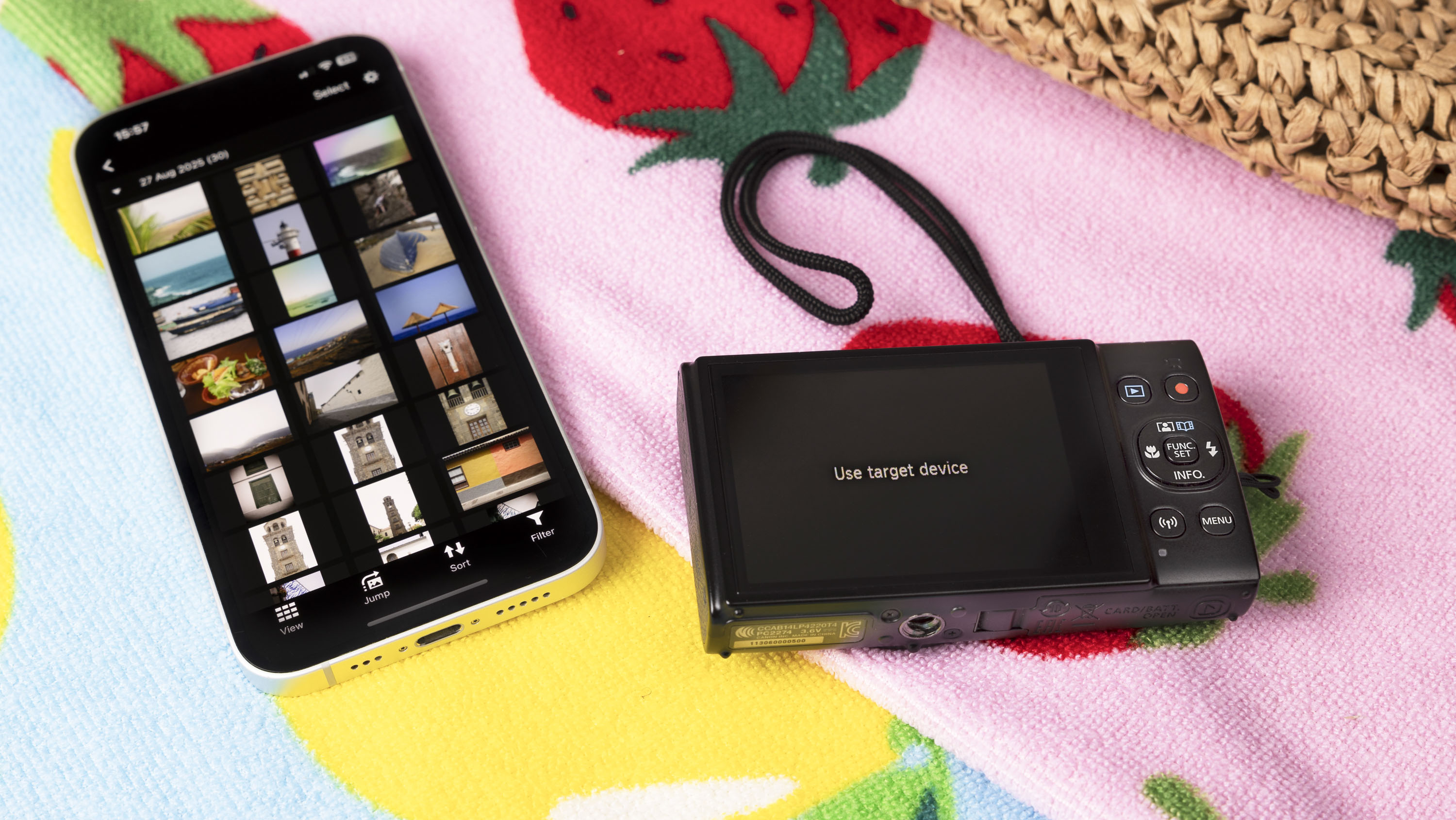 Canon Powershot Ixus 285 HS A Point and Shoot Black, in a brilliant beach towel, along with the telephone with the Canon application