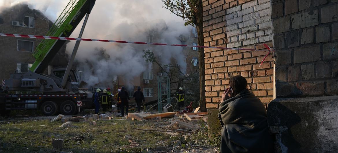 A resident near the ruins of a residential building in kyiv, observing while emergency equipment looking for survivors after a missile strike in the early hours of August 28. A resident near the ruins of a residential building in kyiv, observing while emergency equipment looking for survivors after a missile strike in the early hours of August 28.