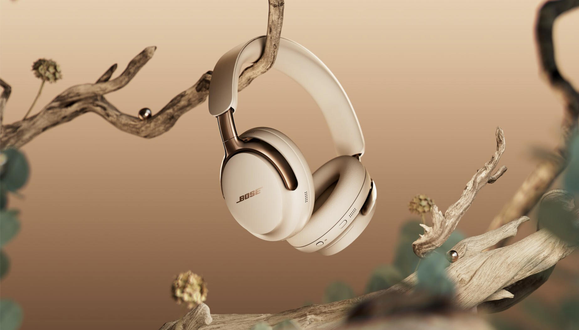 Bose qcu (2nd gen) headphones in 'Driftwood Sand' in the tree branch, with pearls that also grow in the tree