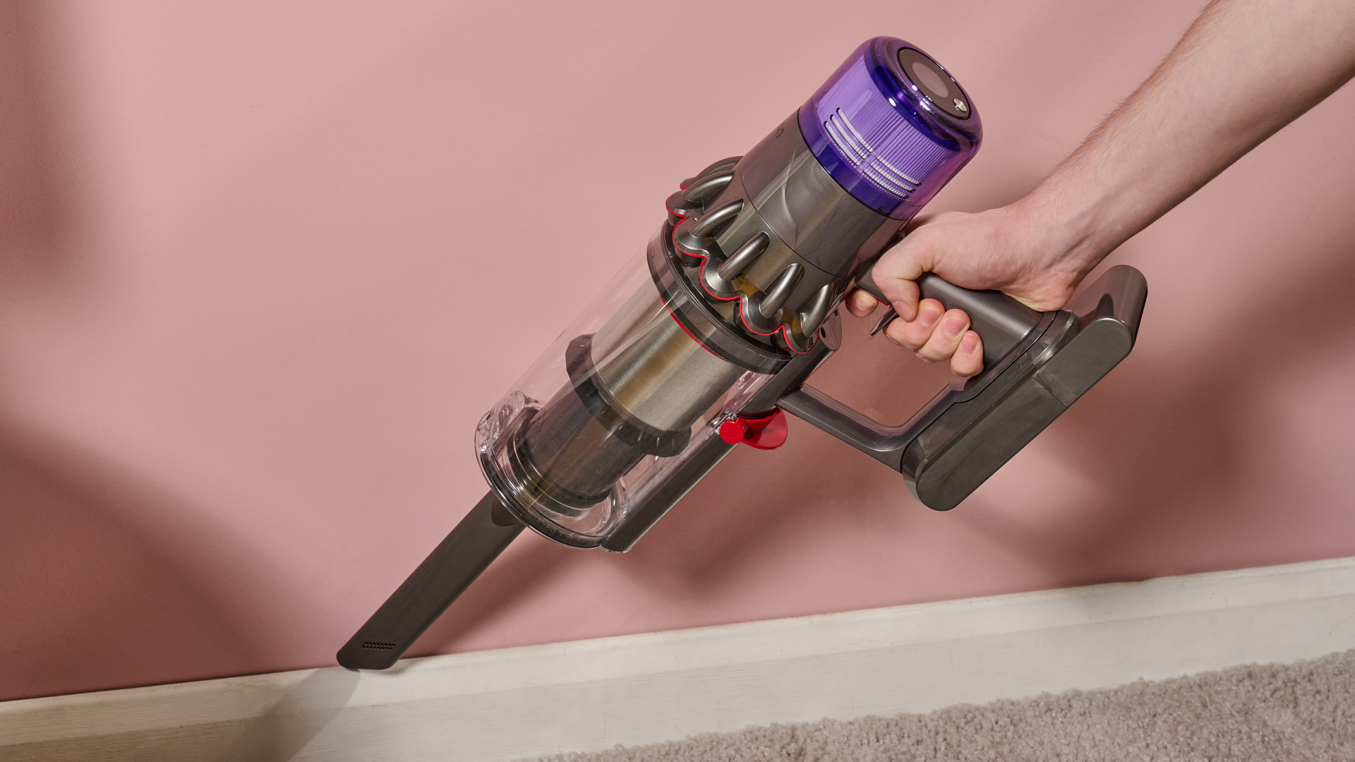Dyson V11 Stick Vacuum in portable mode, with crack accessory, cleaning a plinth