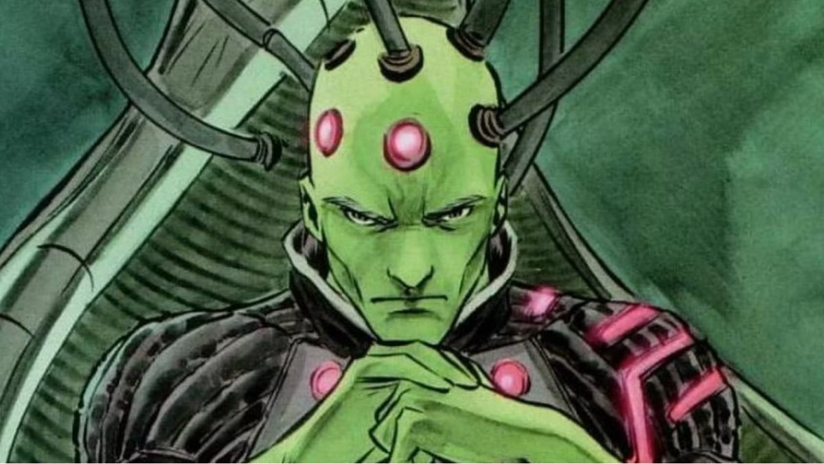 A Brainiac screen capture sitting with tight hands and the head linked to the cables in a DC comic panel