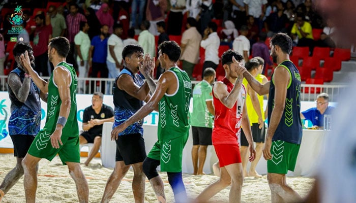 Pakistani and Indian players shake hands after the conclusion of the match on the Khedhufushi City Beach Handball court, on September 18, 2025. - Reporter