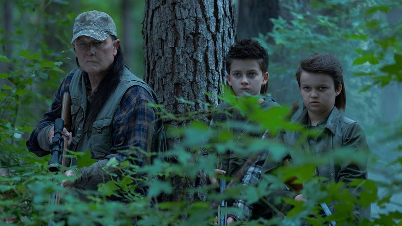 Auggie, Keith and Chris on a hunting trip in a forest in the peaceful season 2 Episode 4