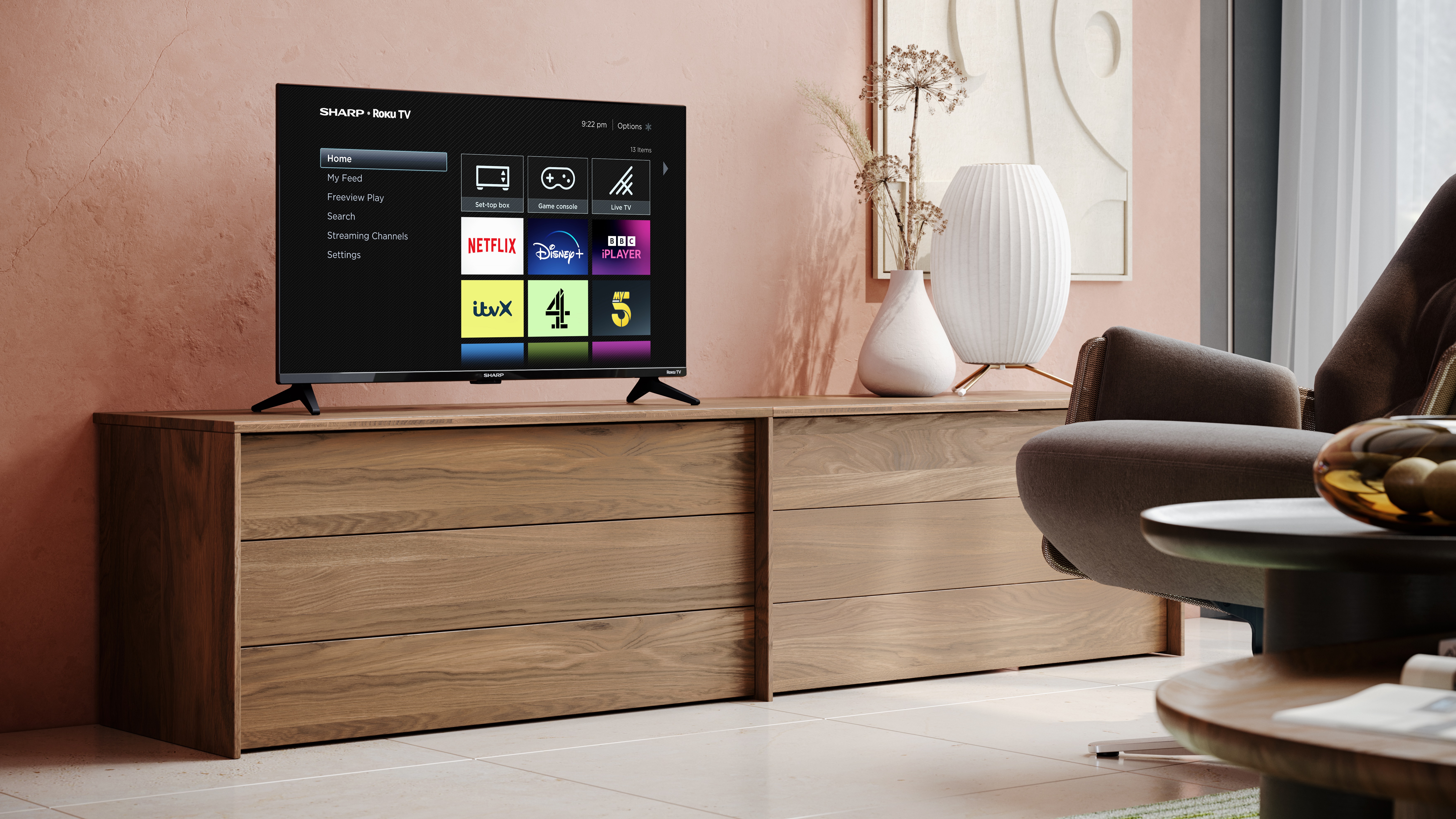 A roku smart tv in a media unit showing the roku's home page