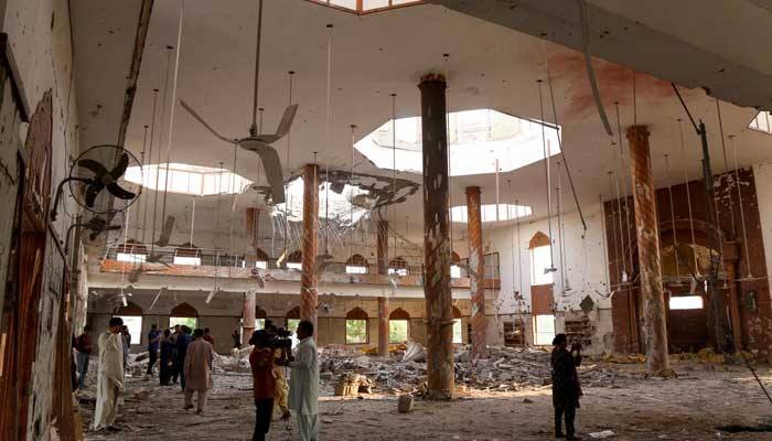 Media members inside a building after it was beaten by an Indian strike in Bahawalpur on May 7, 2025. - Reuters