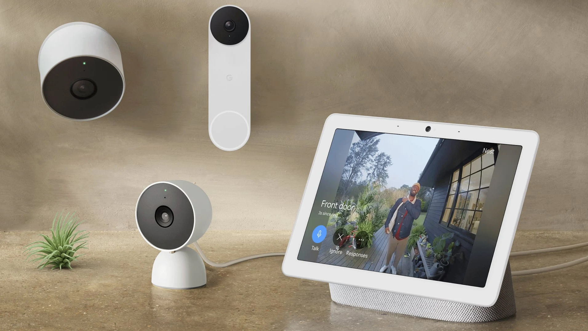 Several Google Nest security cameras next to a pixel tablet on a table