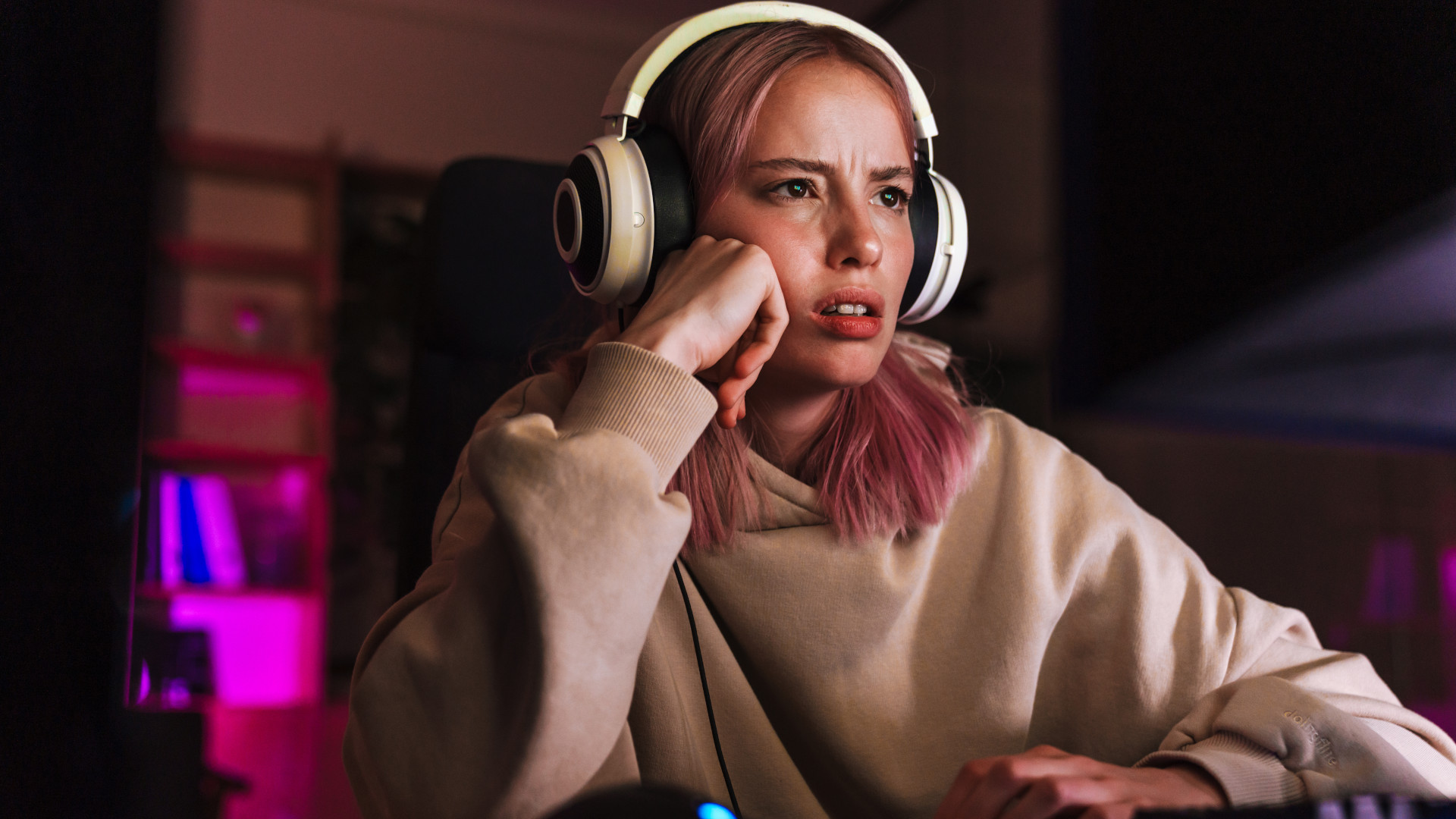 A frustrated -looking girl playing a video game