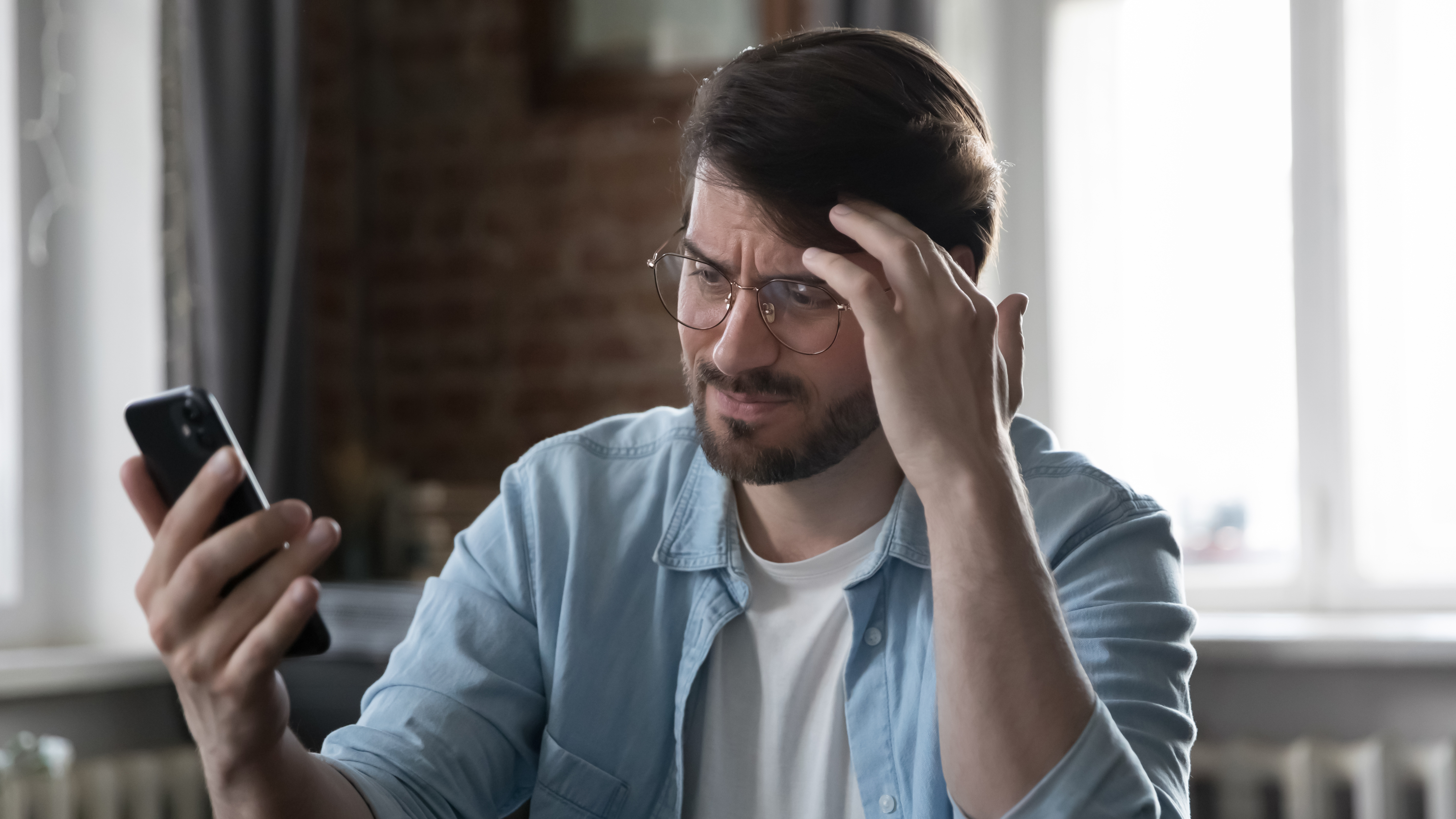 A man who is frustrated on his mobile phone