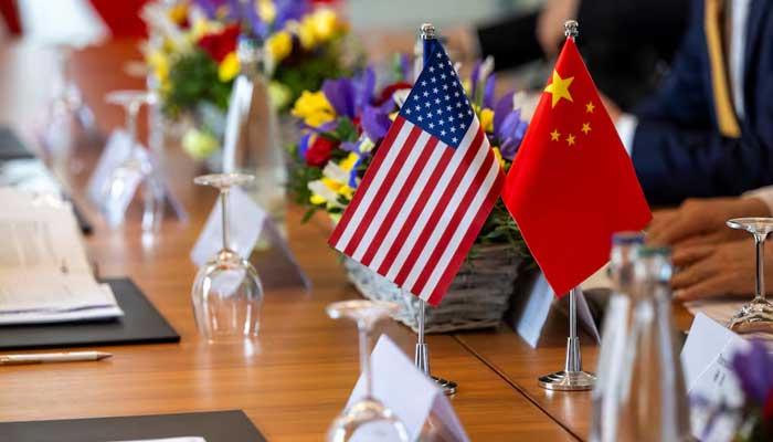 American and Chinese flags are photographed at the negotiating table, during a bilateral meeting between the United States and China, in Geneva, Switzerland, May 10, 2025. - Reuters