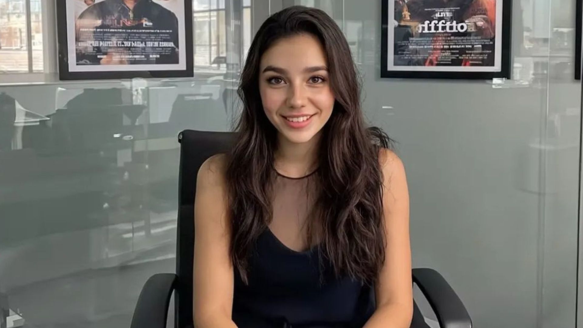 Tilly Norwood, an AI actor, sits in an office looking at the camera