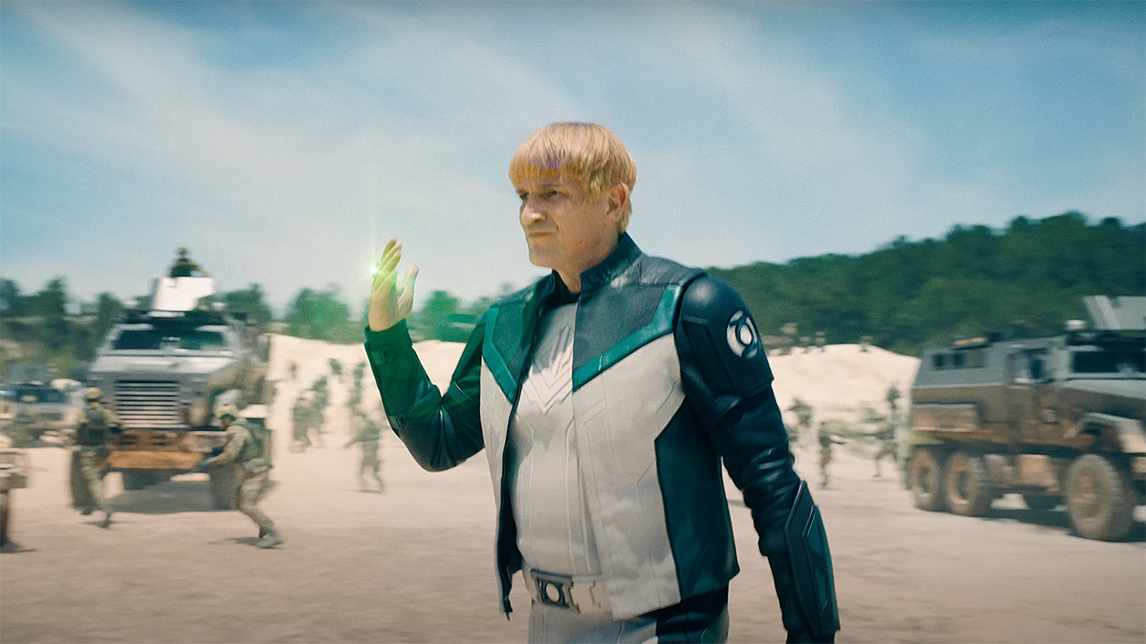 Guy Gardner activating his green flashlight ring in a desert area in Superman
