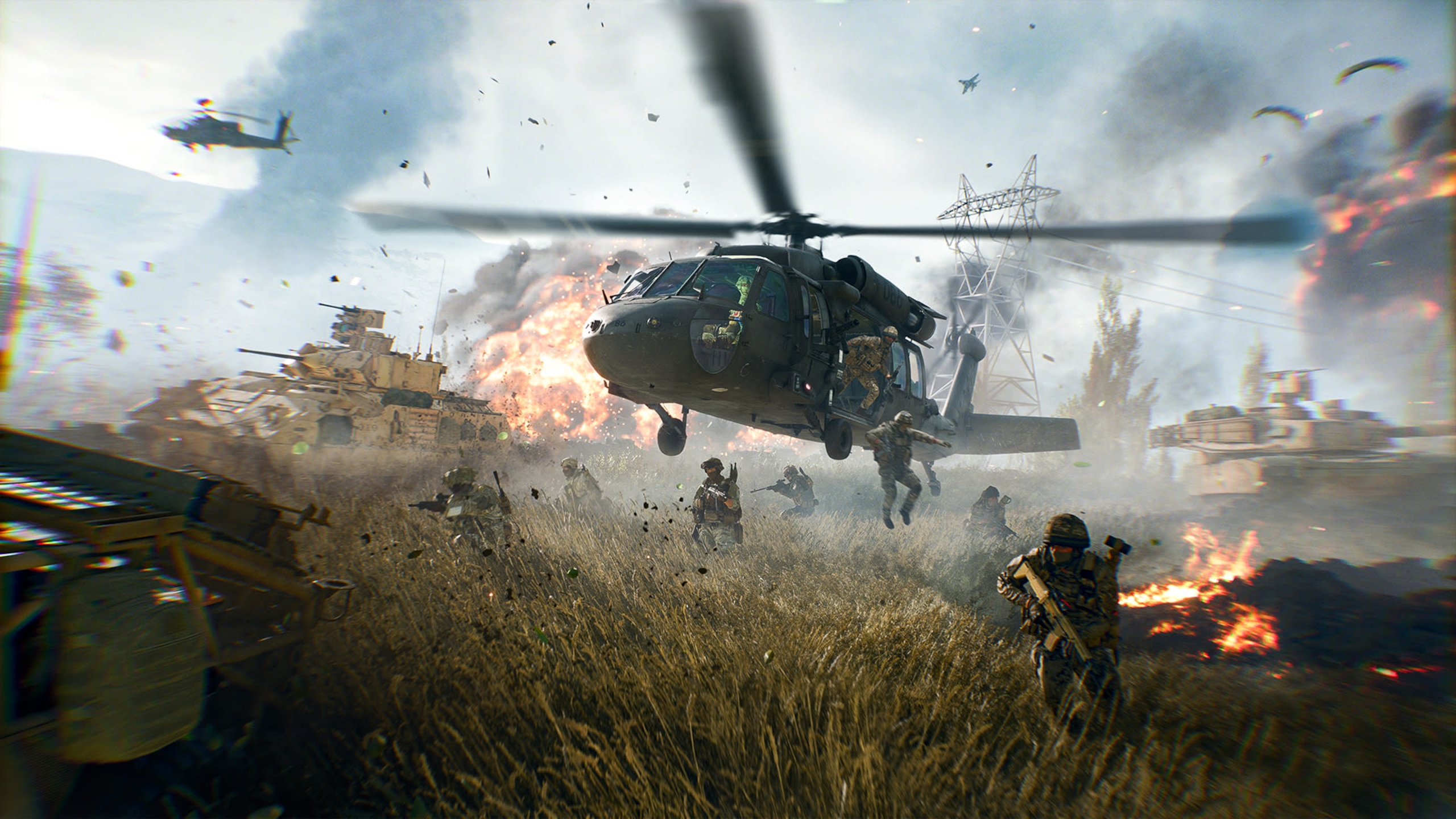 A helicopter lands in the middle of the heat of the battle.