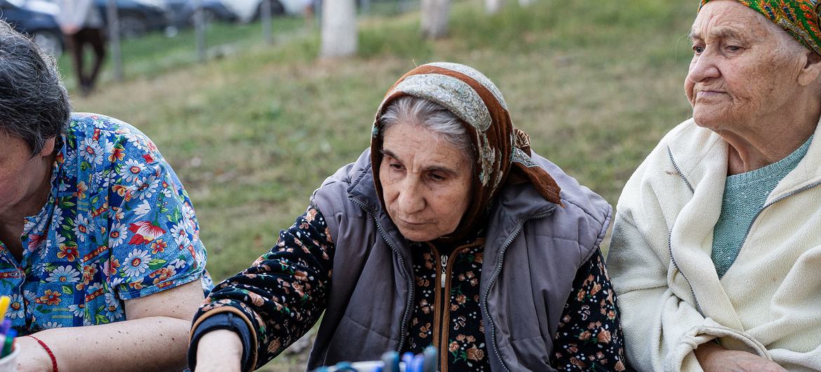 Ana (center) sits with other older women who have sought support in the center of Chișinău.