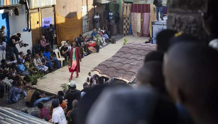 Models wear outfits created by local fashion designers specializing in recycling discarded fabrics and garments from second-hand clothing markets. — AFP