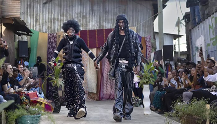 Models wear outfits created by local fashion designers specializing in recycling discarded fabrics and garments from second-hand clothing markets. — AFP