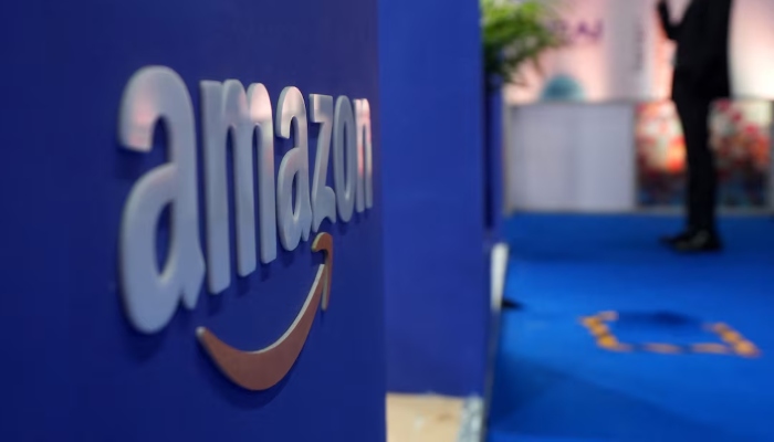 A visitor stands near an Amazon logo during the annual Retail Leadership Summit in Mumbai, India, February 27, 2025. – Reuters