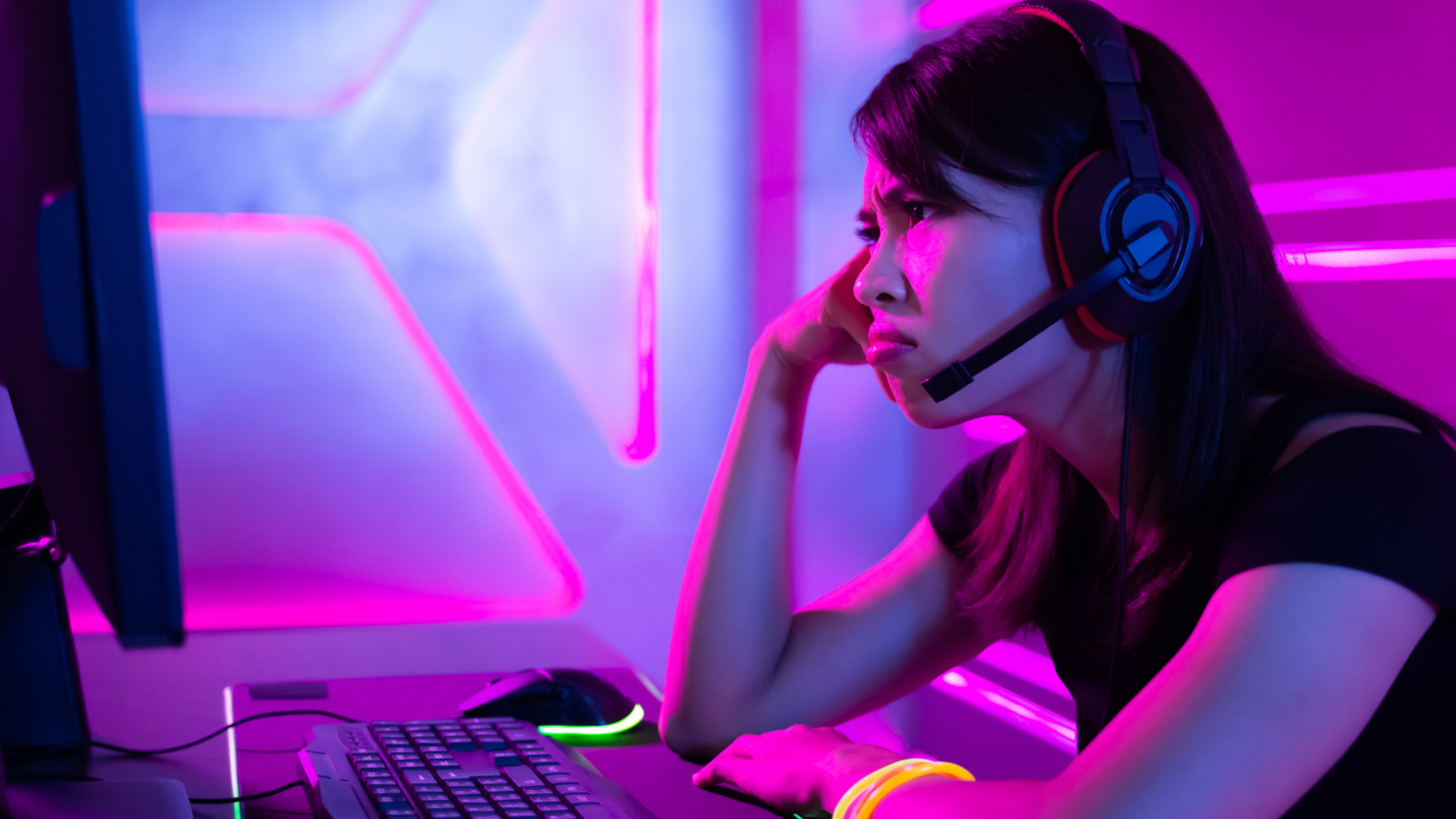 An angry PC gamer sat at his desk and looked unhappy
