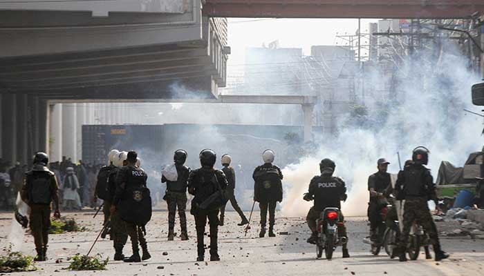 Police officers use tear gas to disperse Tehreek-e-Labbaik Pakistan (TLP) supporters during a solidarity march for Gaza in Lahore, Pakistan, October 10, 2025. – Reuters