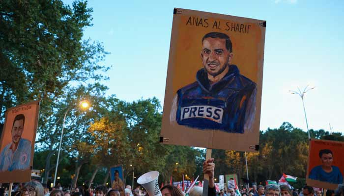 Protesters display a commemorative poster of murdered Palestinian Al Jazeera journalist Anas al-Sharif during a demonstration called by Spanish unions in solidarity with Palestinians in Gaza, in Madrid, Spain, October 15, 2025.— Reuters