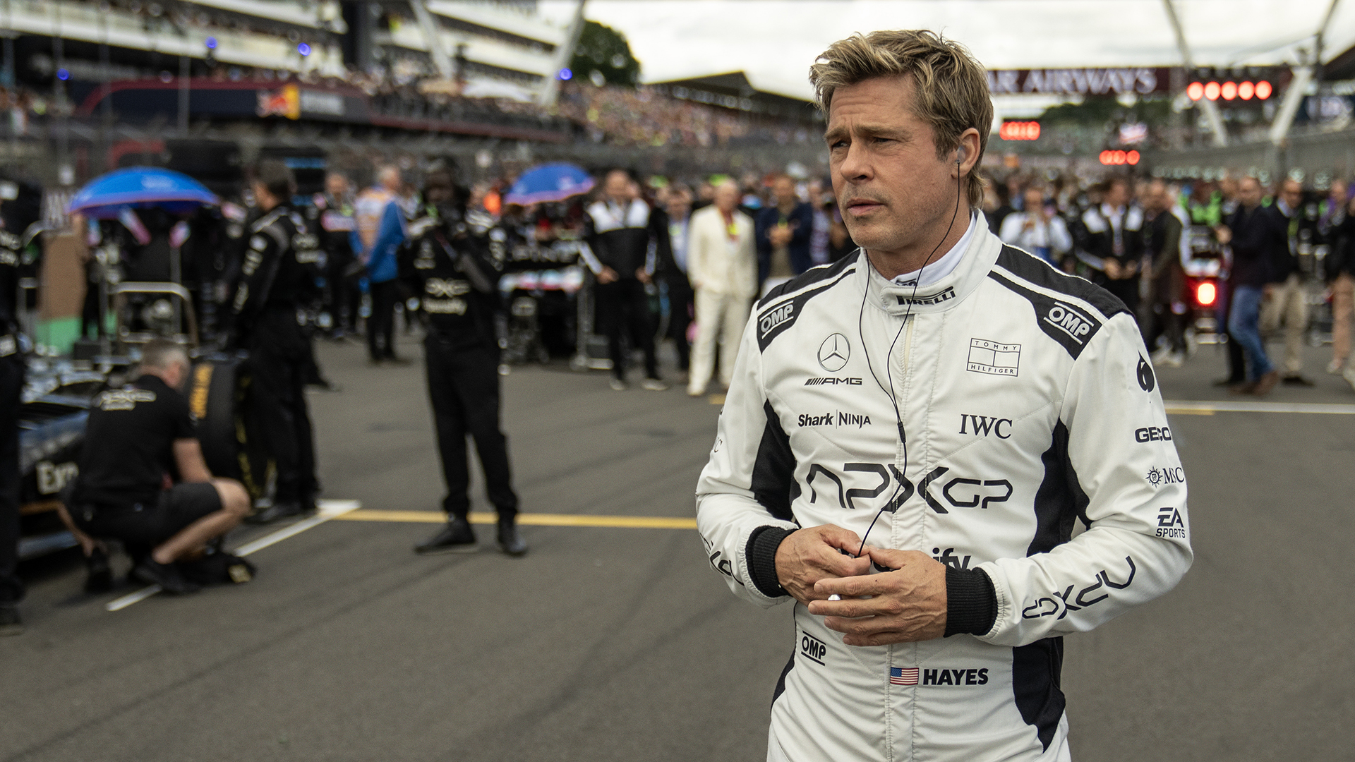 Brad Pitt's Sonny Burch Standing on a Race Track in Apple's F1 Movie